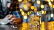 © Валерія Ігнатенко - Highball glass with whiskey on bar next to man on cell phone