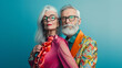 © Dirk - copy space, stockphoto, high resolution, senior Caucasian couple in vivid extravagant outfits and glasses with gray hair, professional photo shoot. elderly couple, man and woman,extravagant vibrant co