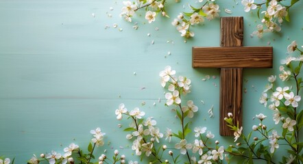 Wooden cross with white flowers on a blue background, in the style of copy space concept for Easter and Bible study designs. Flat lay decoration of a wooden Christian symbol with sprin