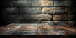 Old wood table with blurred concrete block wall in dark room background, empty wooden table