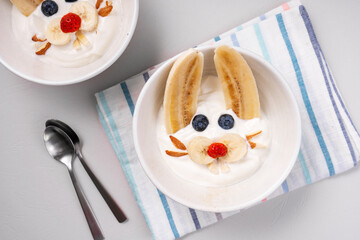 Wall Mural - Kids Breakfast Idea, Rabbit Yogurt Bowl with Banana and Fresh Berries