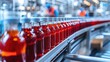 © monvideo - A line of bottles filled with liquid moves along a conveyor belt in a beverage production factory