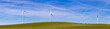 Group of wind generators in a field with green grass in spring, generating electrical energy at no cost to the environment