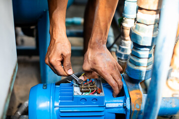 Wall Mural - Selective focus to hand of plumber repair and remove motor of centrifugal water pump. Plumbers working to installation centrifugal water pump motor.