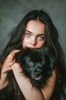 Woman With Blue Eyes Holding Black Dog