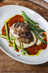 Wall Mural - Appetizing medallions with mashed potatoes and asparagus. Restaurant serving, banquet, food photography