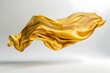 Flowing Golden Silk Scarf Floating in Dramatic Motion Against a Crisp White Background