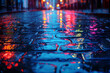 A wet city street illuminated by numerous lights, reflecting the rains slick texture