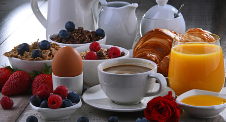 Wall Mural - Breakfast served with coffee, juice, croissants and fruits