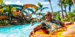 Senior citizen floating on a lazy river ride inner tube at a water park, vacation, tropical, retirement, travel, wide banner, copyspace