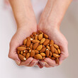 Woman, hands and almonds as fruit of vegetarian for health, wellness and balanced diet with nutrition snacks for farming. Person, fibre and natural vitamin with protein for digestion or weight loss