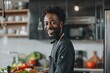 Young African male chef with a happy expression cooking in a modern home kitchen environment
