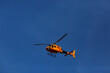 yelow helicopter flying in the sky
