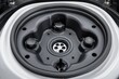 Detailed view of an electric vehicle's wheel well and charging socket, a testament to modern automotive engineering, Concept of electric mobility and vehicle design