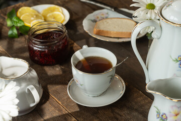 Wall Mural - Tea party. Porcelain tea set on wooden table.