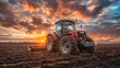 © CtrlN - A red tractor is in a field with a beautiful sunset in the background