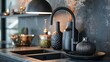 Close-up of a chic kitchen countertop decorated with a black faucet and sink, a contemporary lamp, and elaborate dishes, bowls, and vases.