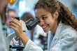 A female student in a lab coat is engaged happily in an experiment using a microscope in a lab setting