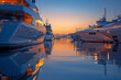 A photograph of a luxury yacht marina at dusk, the boats illuminated and reflecting on the calm wate