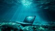 An open laptop resting on the seabed, illuminated by ethereal rays of sunlight filtering through the deep blue water.