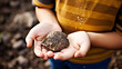Childs hands holding a small fossil, discovery in a backyard, sparking interest in science and paleontology at a young age