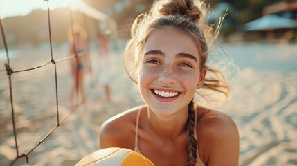 Wall Mural - A happy beautiful woman holds a volleyball, laughing and looking at the camera