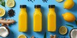 bottle juices with a black lid on a blue background, fresh ginger, coconuts, lemons, tumeric, 