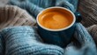 A cup of coffee is sitting on a blanket with some yarn, AI
