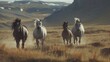 Three horses galloping in field against mountain backdrop