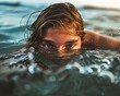 young woman treading water in the ocean, barely staying afloat, face partially underwater