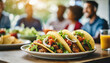 © Your Hand Please - appetizing tacos with friends in blurred background, epitomizing social gatherings and culinary delights
