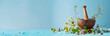 Herbalist at work web banner. Herbalist grinding herbs in mortar and pestle on blue background with copy space.