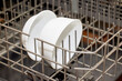 Close up of two white ceramic bowls in the lower rack of a dishwasher