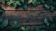Green leaves bordering top edge of rustic wooden background
