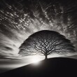 Conceptual image with silhouette of a tree against a cloudy sky. Black and white print art. 
