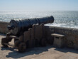 © Barry - Vintage cannon looking out over ocean from fort walls