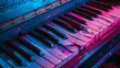A piano with blue and pink neon lights.