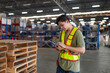 © kelvn - Portrait of male staff with holding clipboard working in warehouse, Industrial and industrial workers concept.