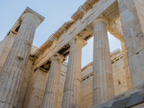 Fototapeta Desenie - Close-up of weathered Ionic columns of a Greek temple ruin, in Athens Greece