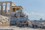 Fototapeta Desenie - Large stones block view of the Caryatids statues on the south porch of the Erechtheion temple at the Acropolis in Athens Greece