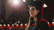 © Keitma - Valedictorian young student woman giving graduation speech to other graduated people from the year group while wearing traditional college regalia and gown