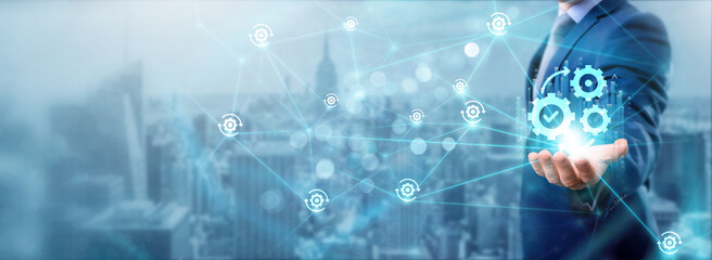 businessman holding automation icon, networking and enhancing efficiency, seamless connection, strea