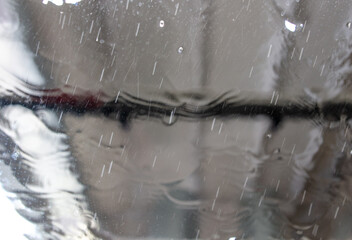 Sticker - Car glass at a car wash In drops of water. Background