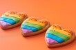 lgbtqia pride bakery food decor conceptual art. Lgbtqia pride. Bakery food decor. Conceptual art. Gay love symbol. Heart gingerbread cookie with rainbow icing decoration isolated on orange. .