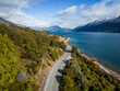 Queenstown, New Zealand: Aerial view of the coastal road along the lake Wakapitu leading to Glenorchy from Queenstown in New Zealand south island on a sunny winter day