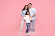 © Home-stock - Happy caucasian family of three, parents and their pretty daughter, posing on plain pastel pink background and smiling at camera. Family day concept