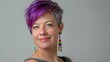 © Chandara - Headshot of woman with short purple hair and rainbow earrings