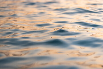 Canvas Print - Beautiful sea waves ripples and sky reflection at sunset sunlight. Dream nature, beauty in nature ocean ecology concept. Artistic golden pastel blue fluid background. Closeup abstract natural light