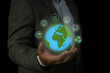 Business man holding green earth and Net Zero icon for net zero emissions target. Environment Social and Governance, Carbon neutral concept net zero