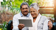 © peopleimages.com - Park, bench and senior couple with tablet for social media, smile and connection with internet. Relax, mature and woman in garden with digital app for reading, post or online memory with nostalgia